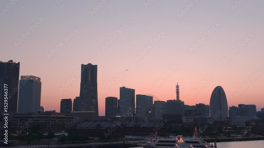 Yokohama, Japan - 05 June 2025 : 4K video of urban night view of Minato Mirai, Yokohama, Japan, taken during early summer sunset time