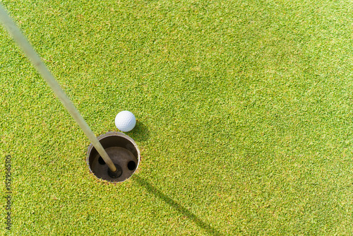Wallpaper Mural Golf ball resting near the hole on putting green with copyspace. Torontodigital.ca