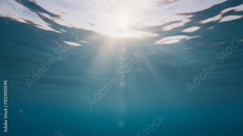 Underwater View with Sunlight Shining Through Rippling Sea Surface