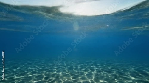 Underwater View of Ocean with Sunlight on Sand Bottom