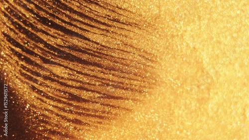Futuristic golden wave of sparkling particles and light flares creating a luxurious abstract background with shimmering dust and bokeh