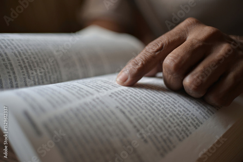 A black man is reading the scriptures or the Holy Bible. The teachings of God according to belief and faith in God. Concept of Religion and faith. Christianity, Islam, Judaism.