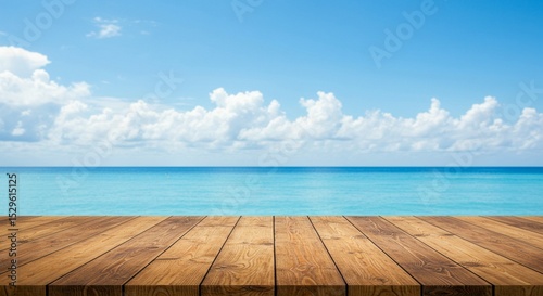 Wooden Deck Overlooking Calm Blue Ocean with Bright Sky and Clouds