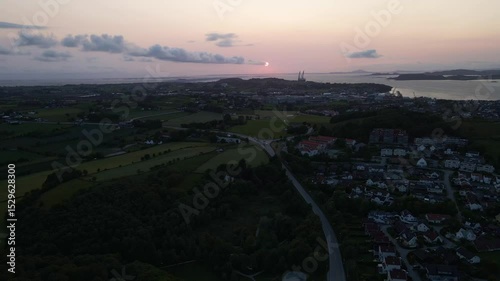 Aerial Shot of a Glowing Red Sunset Over Expansive Fields

 photo