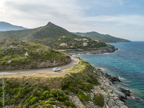 Aerial view car Roadtrip Winding road along rocky coast of Cap Corse peninsula on Corsica island France