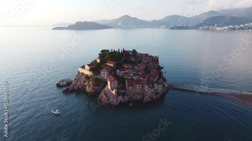 Aerial view of Sveti Stefan island and beach in Montenegro with stunning architecture and vibrant blue Adriatic Sea.