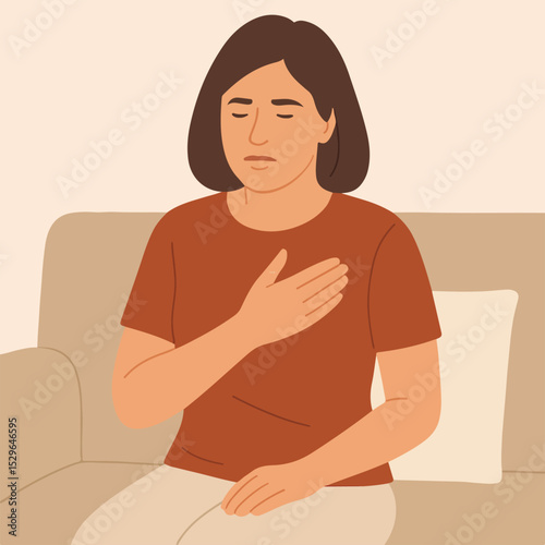 A woman with chest pain is sitting on the couch.