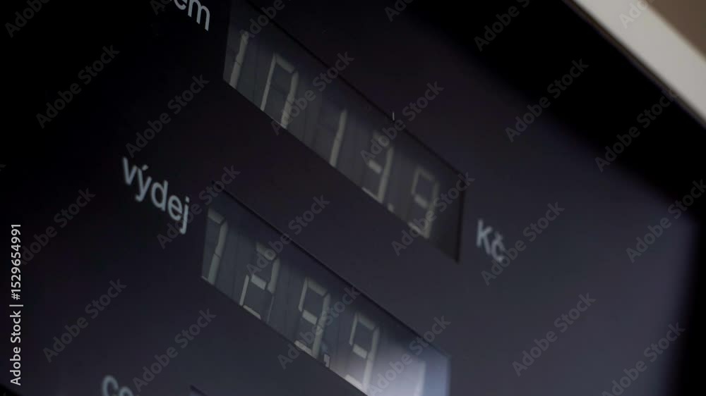 Close-up of an old mechanical fuel pump counter flipping numbers as fuel flows. A nostalgic moment capturing vintage engineering, analog precision, and the charm of classic gas station design.

