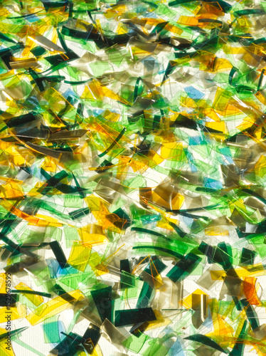 Plastic background. Recycling background. Zero waste. Plastic recovery. Reusable of old plastic. Second life. Recycling, reuse, circular, reprocessing. Colorful pieces of PET repurposing.