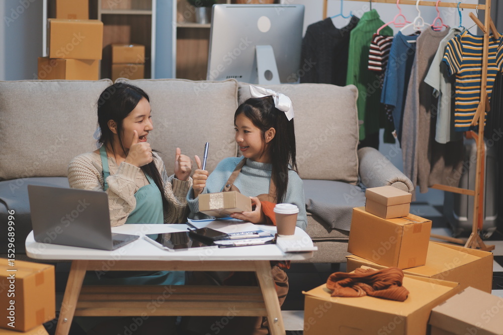 Fototapeta premium Young asian women happy after new order from customer. Surprise and shock face of asian woman success on making big sale of his online store. Online Selling. Online Shopping