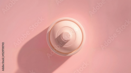 Top View of a White Bottle Cap on a Pink Background represents the concept of minimalist design and simplicity.