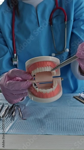 Dental demonstration using a model to explain oral care techniques in a clinical setting