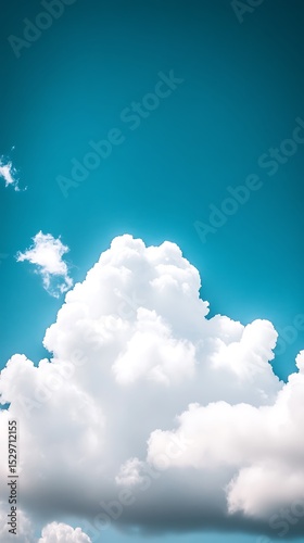Magnificent cumulus clouds floating gently in expansive azure summer sky