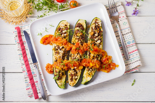 Zucchini stuffed with minced beef on plate. Zucchini boats. Loaded courgettes. View from above, top studio shot