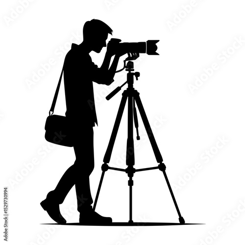 Young man taking photograph with camera on tripod in silhouette  