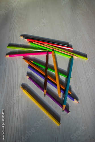 colored pencils are lying on the floor