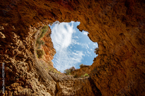 Looking Up at the Blue Sky Through the Famous Oculus of the Benagil Sea Cave (Algar de Benagil) in Algarve, Portugal