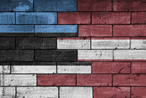 colourful painted big national flag of latvia and flag of estonia on a massive old brick wall background. concept