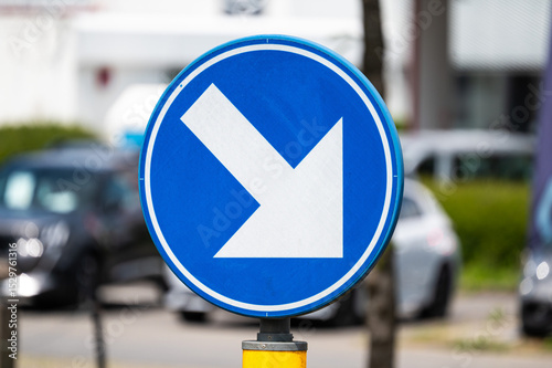 Blue road sign with direction arrow in Vilvoorde, Flemish Brabant, Belgium