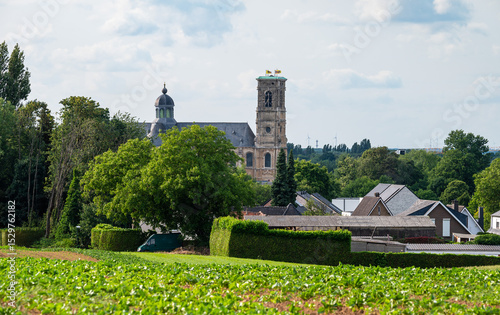 Landscape view over green fields and the Abbey tower of Grimbergen, Flemish Brabant, Belgium
