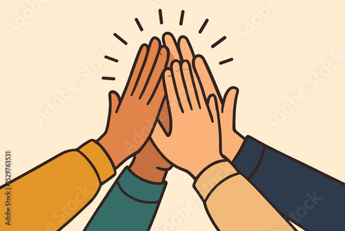 Group of diverse hands giving a high five. Concept of teamwork, unity, success, and collaboration. Multicultural team celebrating achievement. Partnership and community support.
