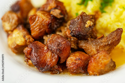 Pieces of juicy pork baked until brown with mashed potato.