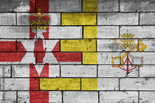 colourful painted big national flag of vatican city and flag of northern ireland on a massive old brick wall background. concept