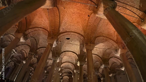 Basilica Cistern , a wide-angle view capturing the columns, arches, and detailed brickwork of an underground historic structure, emphasizing its architectural grandeur