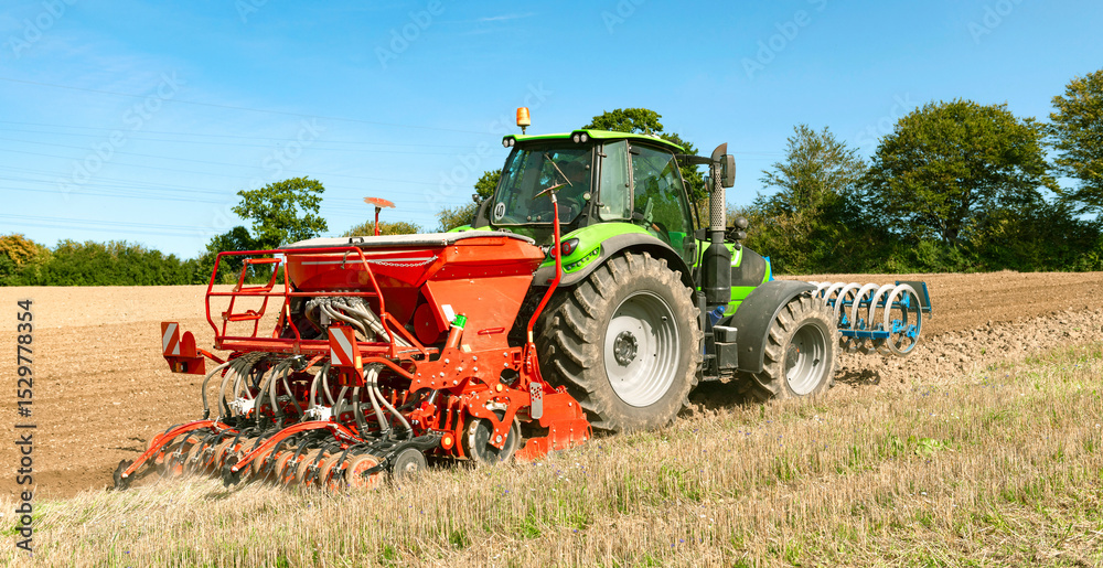 Obraz premium Tractor with seed drill, rotary harrow, and front packer tilling the field - 3592