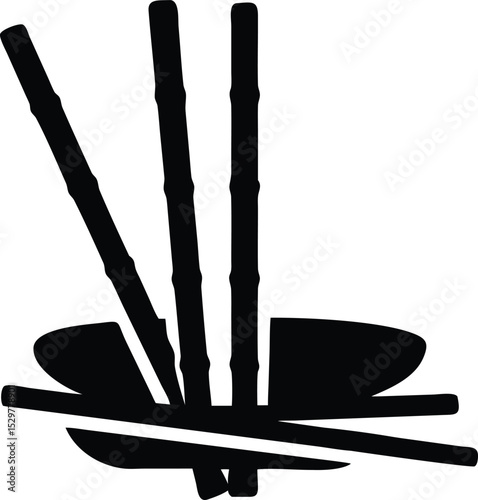 Black wooden chopsticks rest on a white background, a common isolated tool set