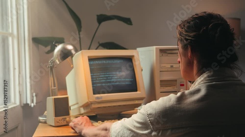 Man working and gaming on retro computer PC, IT engineer with vintage computer at home, using old fashion technology, close up of retro setup. 