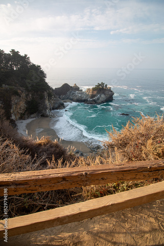 Iconic McWay Falls Cascading onto a Secluded Beach in a Turquoise Cove at Sunset in Big Sur, California