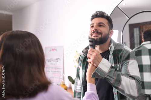 While playing, daughter combs her father's beard