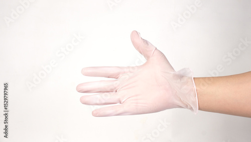 Hands is wearing  a disposable white latex or nitrile glove on white backround.