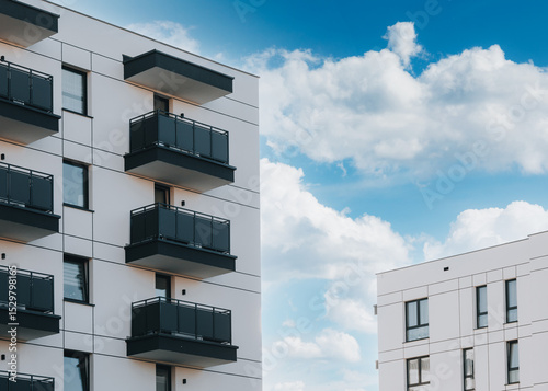 Vászonkép Modern apartment building with balconies against blue sky