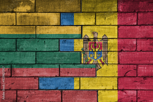 colourful painted big national flag of moldova and flag of lithuania on a massive old brick wall background. concept