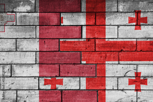 colourful painted big national flag of georgia and flag of malta on a massive old brick wall background. concept