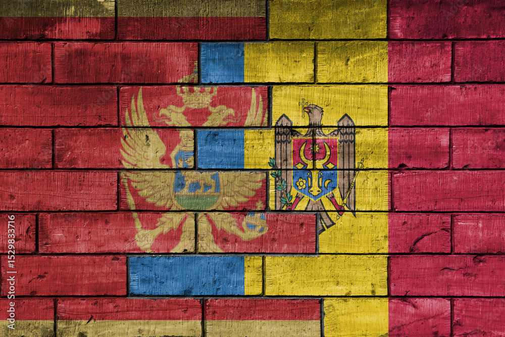 Fototapeta premium colourful painted big national flag of moldova and flag of montenegro on a massive old brick wall background. concept
