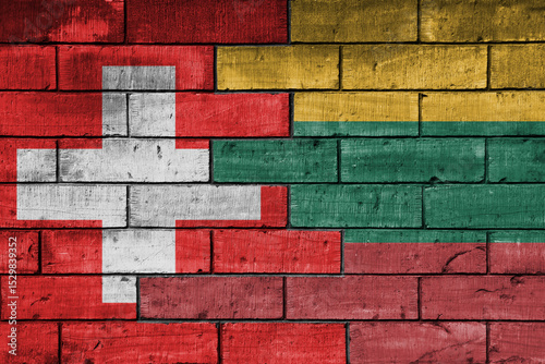 colourful painted big national flag of lithuania and flag of switzerland on a massive old brick wall background. concept