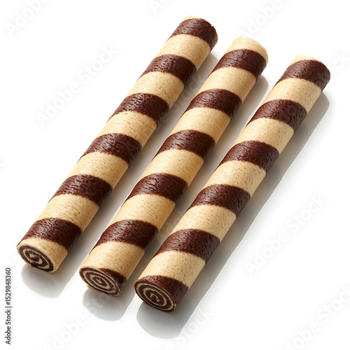 Three elegant chocolate vanilla striped wafer cookie rolls with spiral swirl pattern design photo