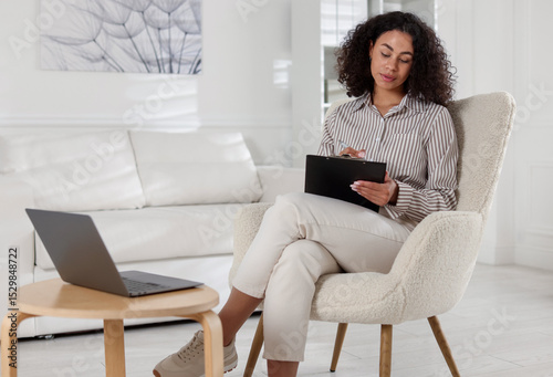 Free Download Professional psychologist taking notes while working with laptop in office - GFXLoad