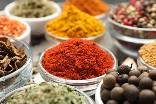 Fototapeta Naklejka Na Ścianę i Meble -  Different aromatic spices in bowls on table, closeup
