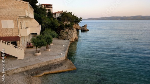 Fototapeta Naklejka Na Ścianę i Meble -  beautiful coastal landscape sunrise scenery, natural rock formations at sandy beach, with mountain Biokovo in background, Mimice, Dalmatia, Croatia, Adriatic sea at Mediterranean