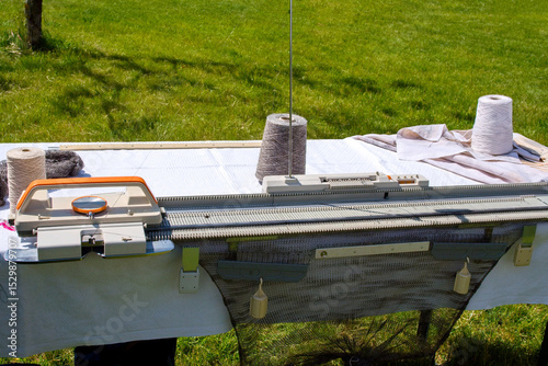 Knitting Machine Set Up Outdoors. Manual Knitting Machine and Wool Spools