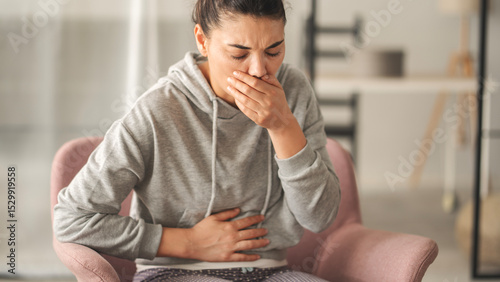 Young woman feeling nauseated at home