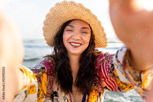 Romanian woman taking a selfie on the beach, embracing summer vibes