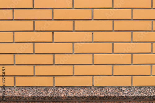 Brick wall texture, background. Orange brick wall background for exterior design. Construction concept, outdoor buildings, garage or house. Wall with classic checkerboard pattern and visible joints