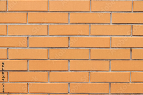 Brick wall texture, background. Orange brick wall background for exterior design. Construction concept, outdoor buildings, garage or house. Wall with classic checkerboard pattern and visible joints