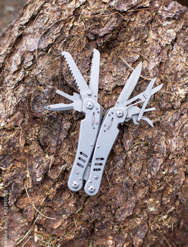 multitool in the forest, on a tree trunk
