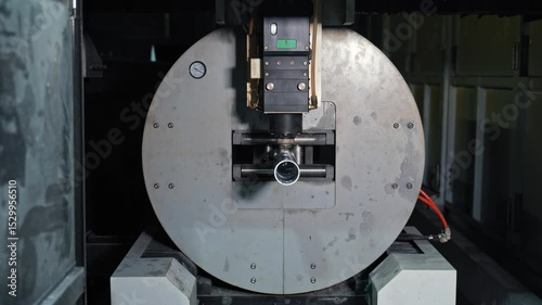 Industrial CNC laser machine cutting metal cylinder, precision high-tech process, Automated rotation mechanism ensures accurate detailing for mass production